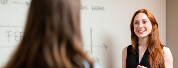 Female teacher smiling at whiteboard