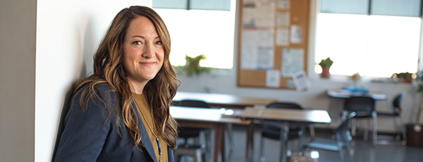 Happy teacher outside classroom 600x230