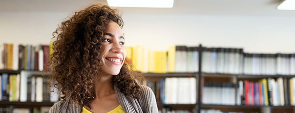 Happy young student in the library 600x230