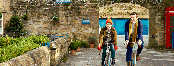 Young man and woman with bicycles in the Peak District area of Derbyshire