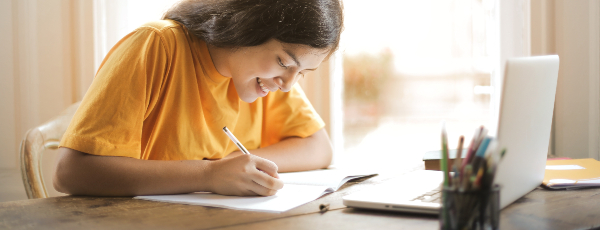 woman in yellow shirt writing on white paper 3807755